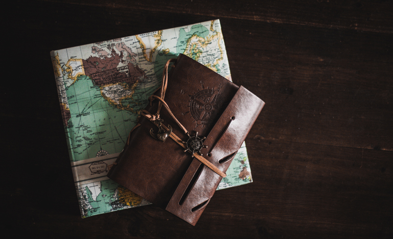Image of a map and suitcase with a compass