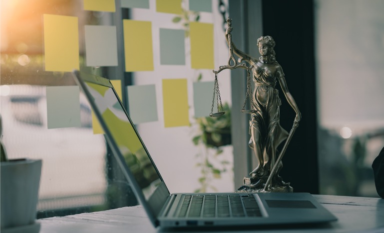 Justice scales concept with laptop