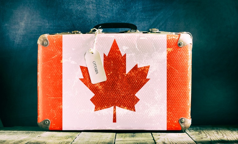 Old suitcase with Canadian flag