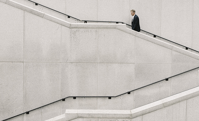 Man in suit walking up stairs