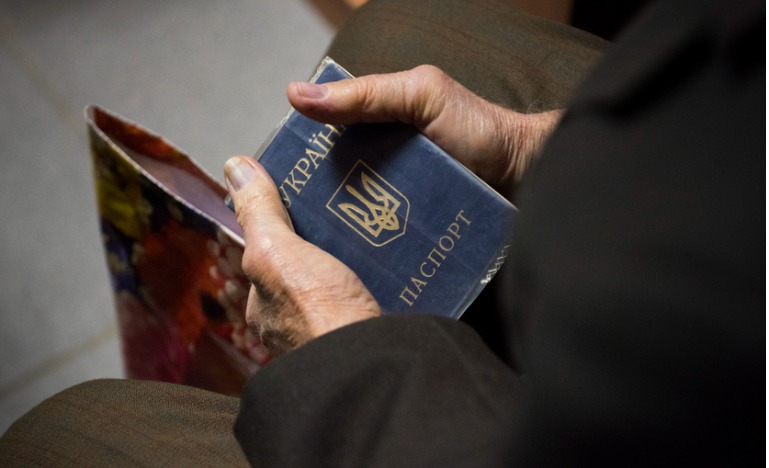 Man holding Ukrainian passport