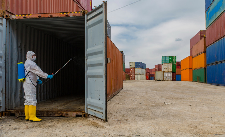 Disease control service Staff Disinfect Cargo To Prevent Spread COVID-19 stock