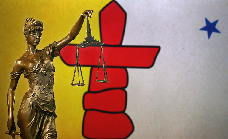 Lady Justice before a flag Nunavut