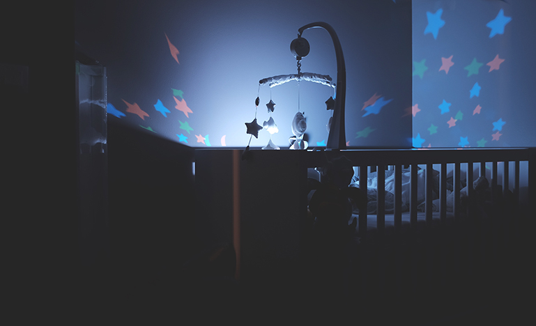 Image of a crib with a mobile