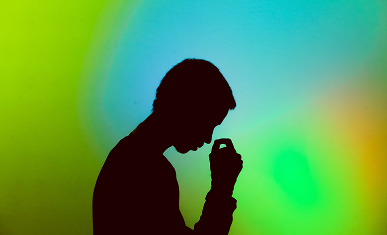 silhouette of person in front of green background