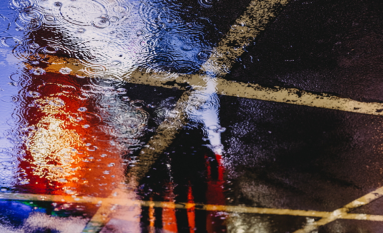 reflection of a person in the rain