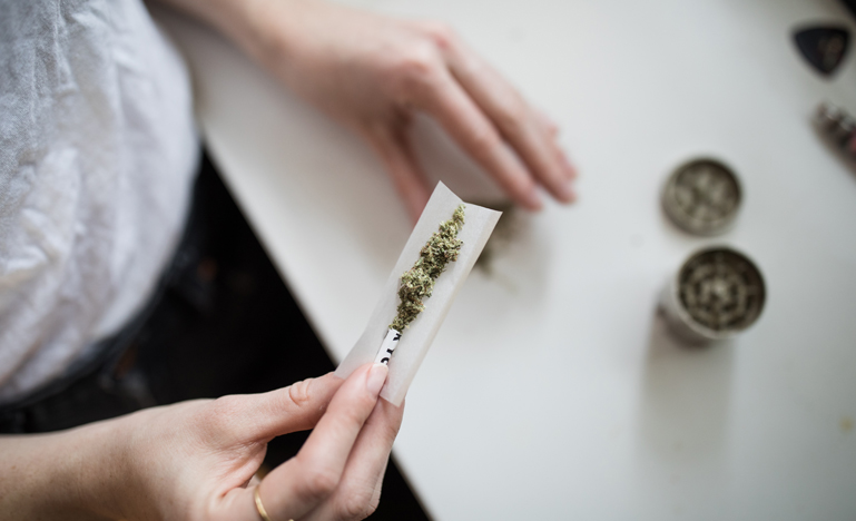 Person rolling marijuana