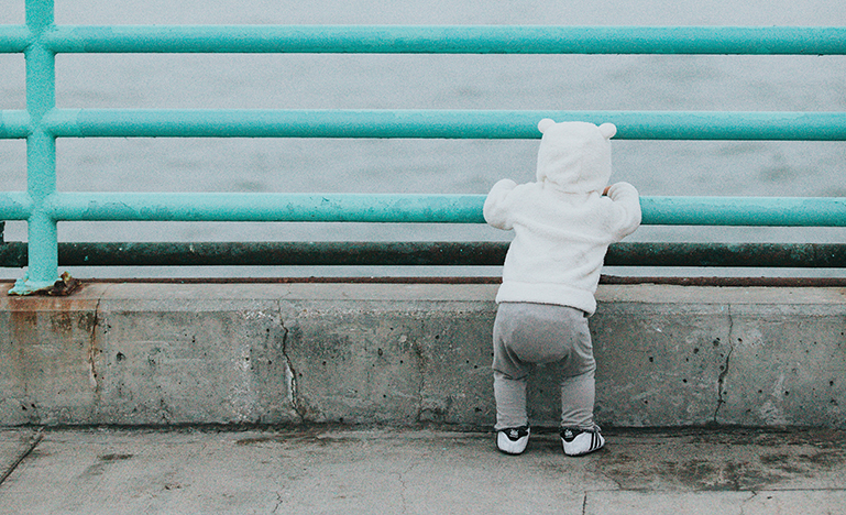Little kid looking out into water