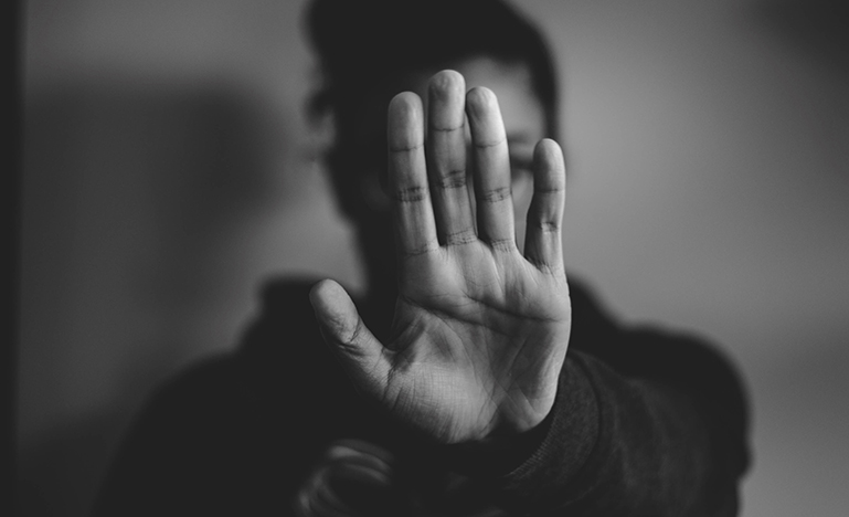 Person holding up hand