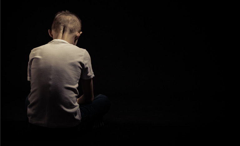 Rear view of a sad boy