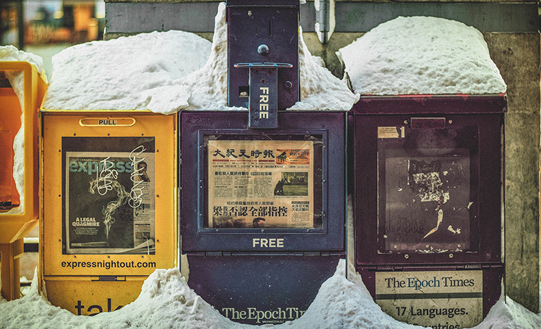 newspaper boxes covered in snow