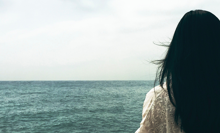 Woman looking out into ocean