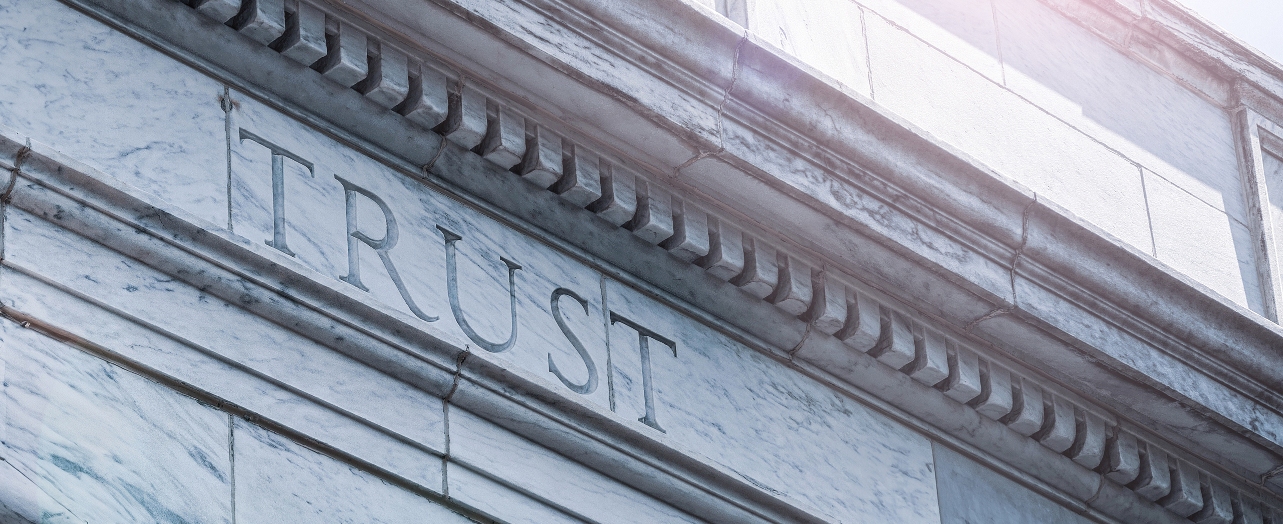 Trust word carved in a wall