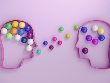 Des têtes humaines reliées par des sphères multicolores, symbolisant le mentorat