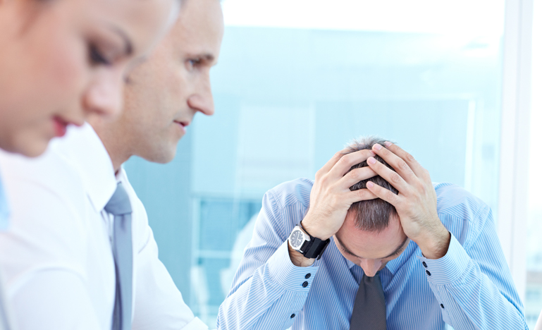 People around a board table worried
