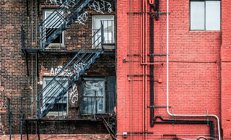 Back of a building with graffiti on it
