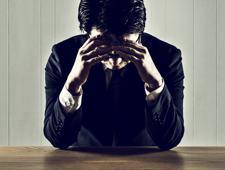 Businessman holding a head