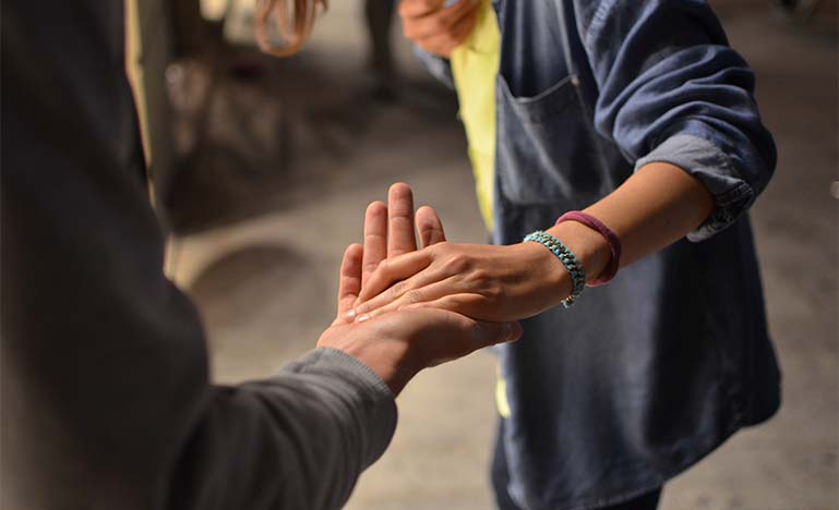 Woman grabbing man's hand