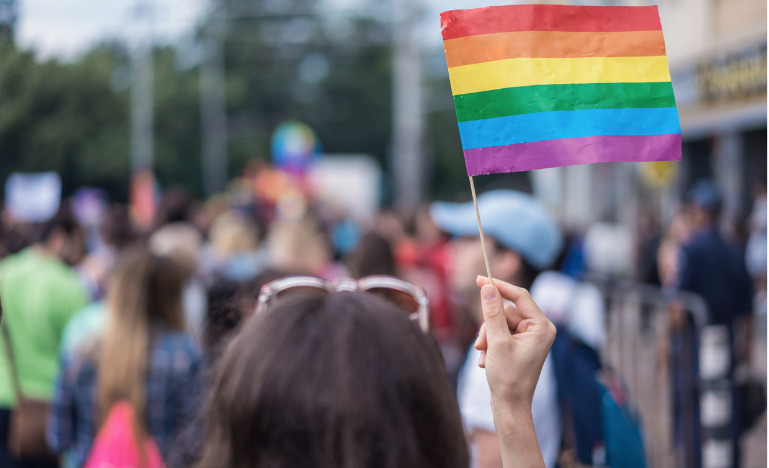 Woman holding rainbow flag