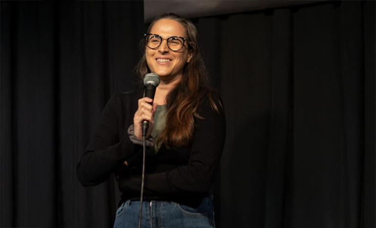 Lawyer Nadia Halum performing at a comedy club