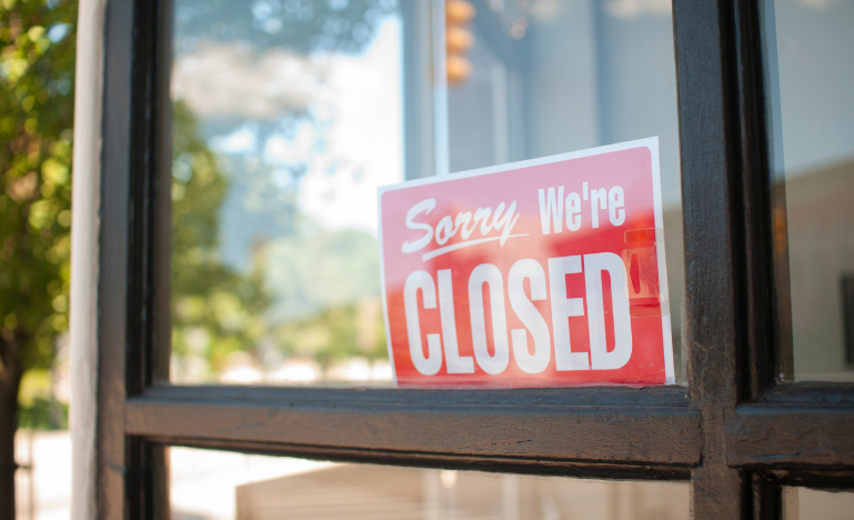 A closed sign in the window of a business