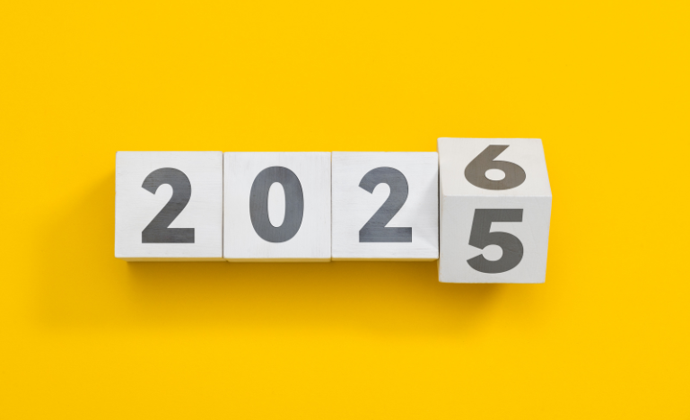 Wooden cube block change from 2025 to 2026 on yellow background
