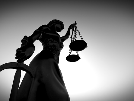 Themis with the scales of justice and a sword.