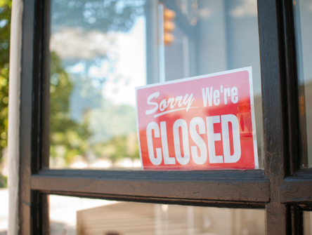 A closed sign in the window of a business