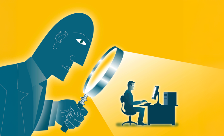 Big Brother looks through a magnifying glass at a small man who is sitting at a computer.