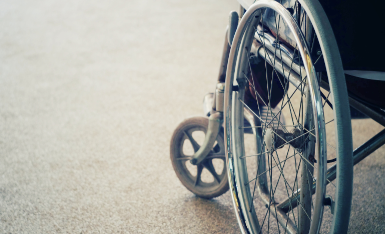 A personal injury client sits in a wheelchair