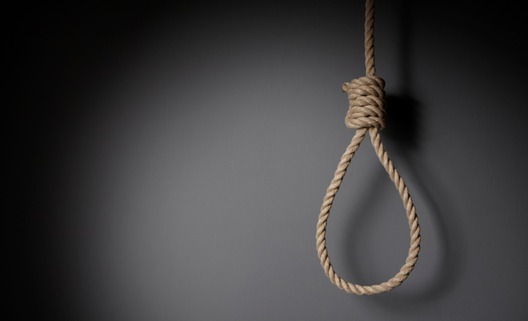 A noose hangs in front of a grey background