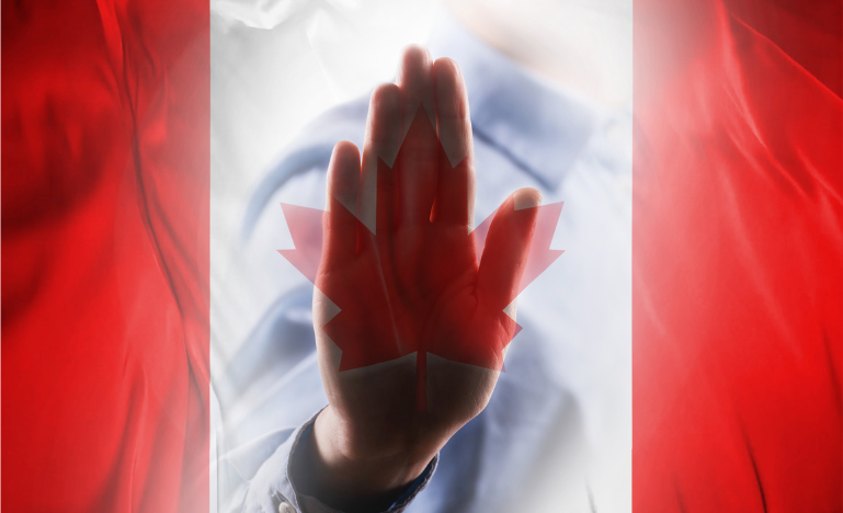 A Canadian flag with a hand stop sign