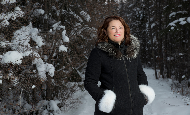 Sandra MacKenzie in the snowy woods near Yellowknife