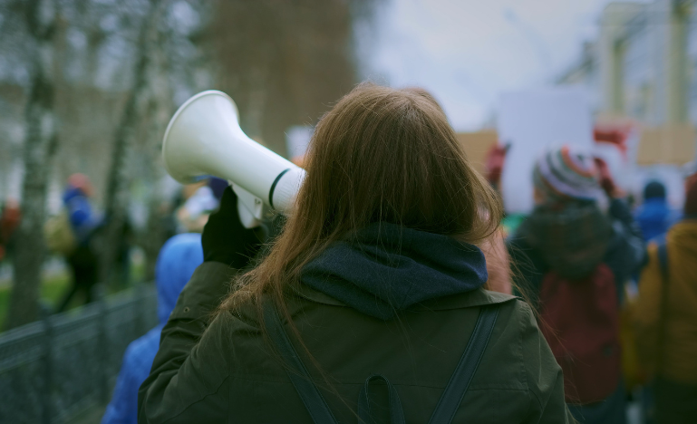 Woman on a megaphone during a labour strike