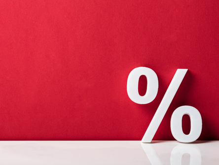 A white percentage sign on a red backdrop
