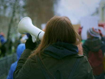 Woman on a megaphone during a labour strike