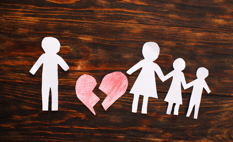 Paper chain cut family with broken heart on wooden background