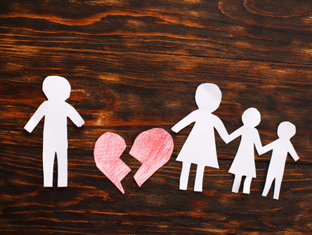 Paper chain cut family with broken heart on wooden background